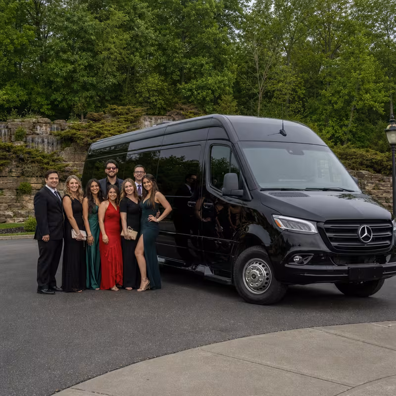 Group beside a Mercedes Sprinter limo from the Fort Wayne fleet