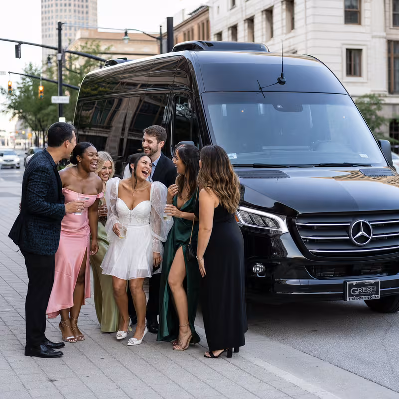 Group boarding a white charter bus for Bachelor & Bachelorette Transportation transportation in Fort Wayne