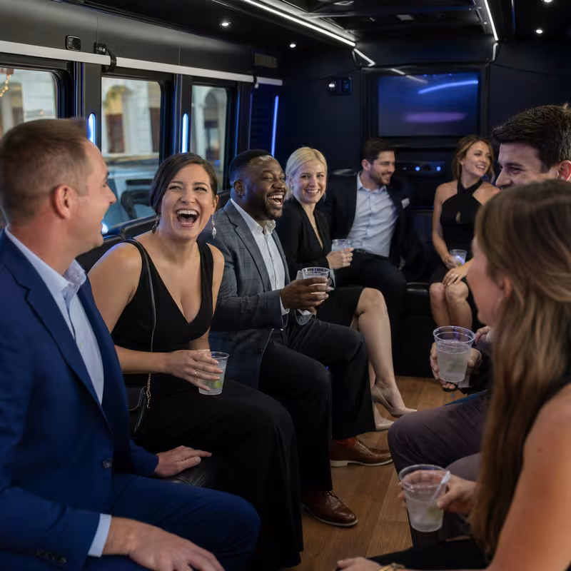 Party bus interior with wraparound leather seating and LED lighting in Fort Wayne