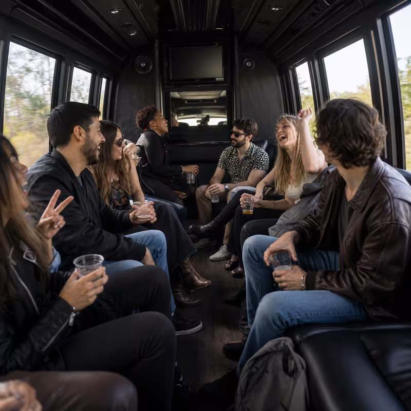 Group boarding a white charter bus for Concert Transportation transportation in Fort Wayne