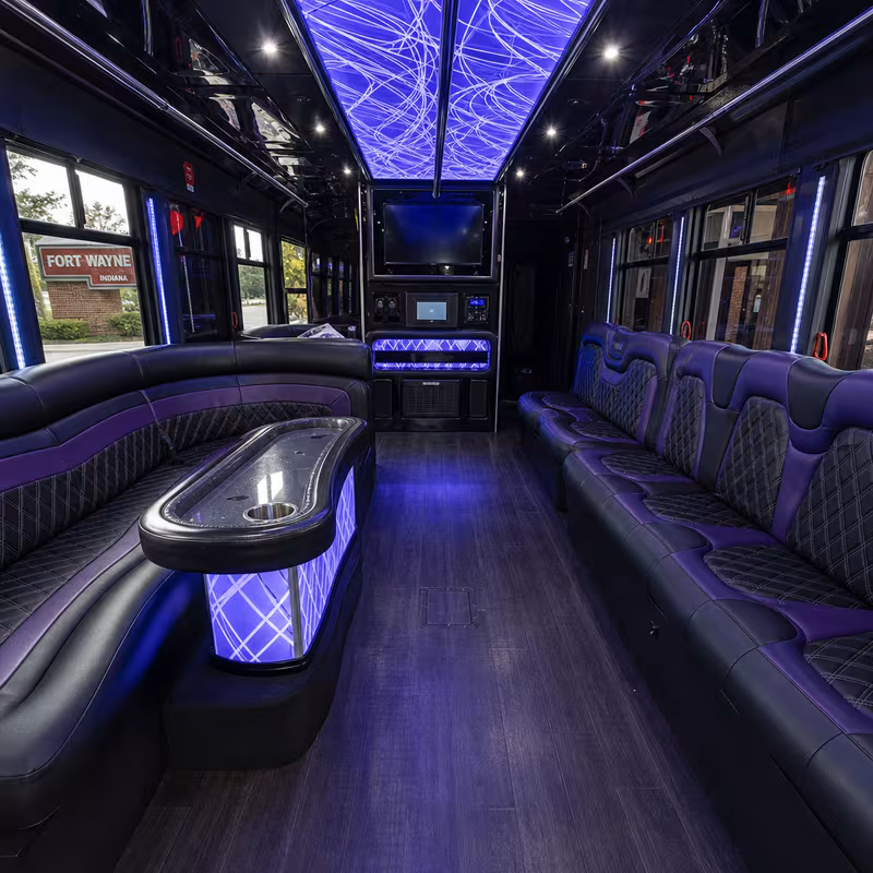 Party bus interior with wraparound leather seating and LED lighting in Fort Wayne