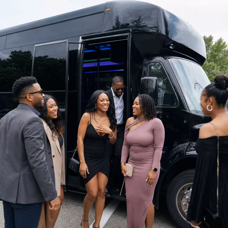 Passengers loading luggage while boarding an Fort Wayne group shuttle