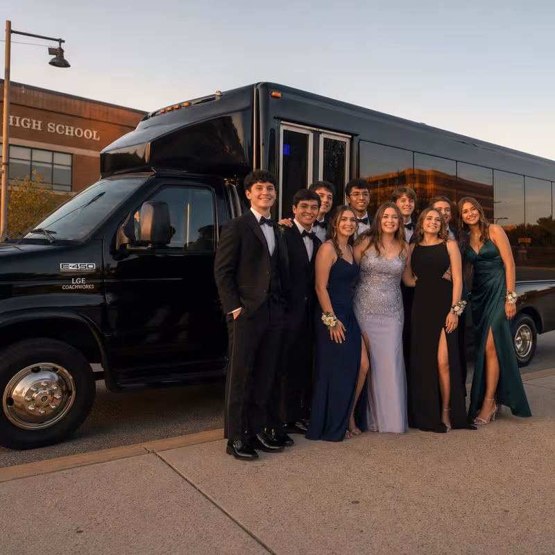 Group boarding a white charter bus for Prom & Homecoming Transportation transportation in Fort Wayne