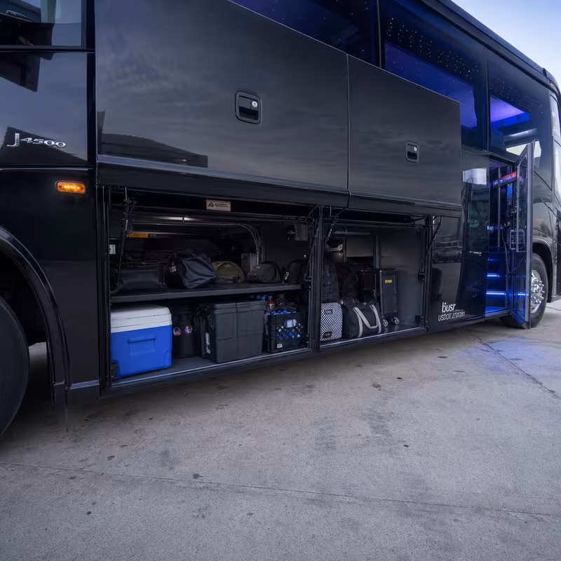 Party bus interior with wraparound leather seating and LED lighting in Fort Wayne
