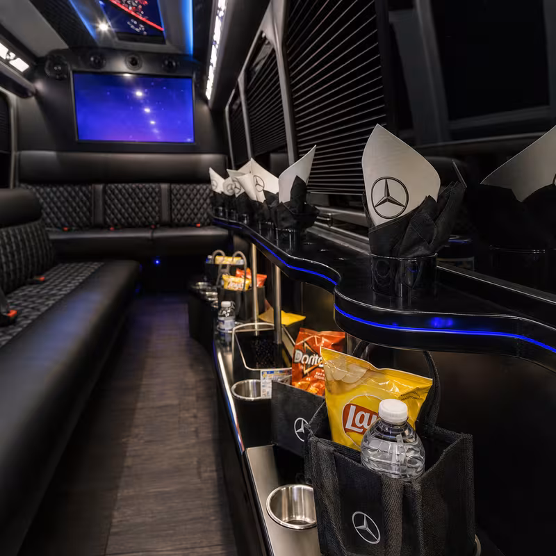 Party bus interior with wraparound leather seating and LED lighting in Fort Wayne
